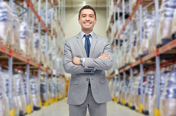 Image showing happy man in suit and tie over warehouse