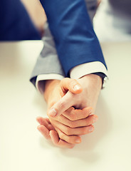 Image showing close up of happy male gay couple holding hands