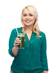 Image showing smiling woman drinking vegetable juice or smoothie