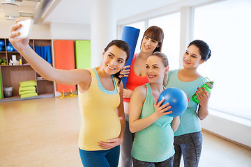 Image showing pregnant women taking selfie by smartphone in gym