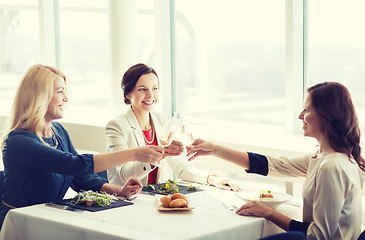 Image showing happy women drinking champagne at restaurant