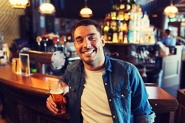 Image showing happy man drinking beer at bar or pub