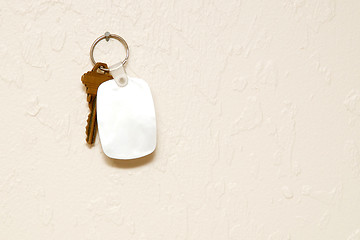 Image showing Keyring with key and fob on wall