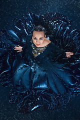 Image showing The young beautiful modern dancer dancing under water drops