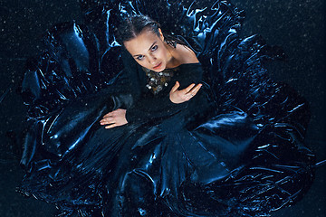 Image showing The young beautiful modern dancer posing under water drops