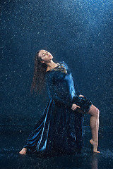 Image showing The young beautiful modern dancer dancing under water drops