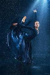 Image showing The young beautiful modern dancer dancing under water drops