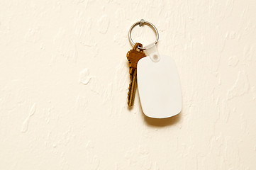 Image showing Keyring with key and white fob on wall