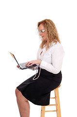 Image showing Business woman sitting and working with laptop.