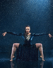 Image showing The young beautiful modern dancer dancing under water drops