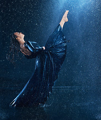 Image showing The young beautiful modern dancer dancing under water drops