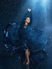 Image showing The young beautiful modern dancer dancing under water drops