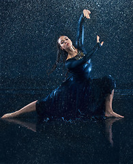 Image showing The young beautiful modern dancer dancing under water drops