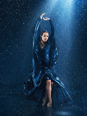 Image showing The young beautiful modern dancer dancing under water drops