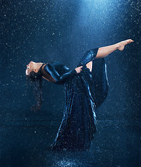 Image showing The young beautiful modern dancer dancing under water drops