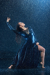 Image showing The young beautiful modern dancer dancing under water drops