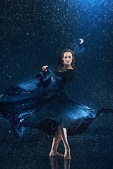 Image showing The young beautiful modern dancer dancing under water drops