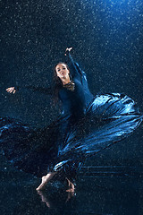 Image showing The young beautiful modern dancer dancing under water drops