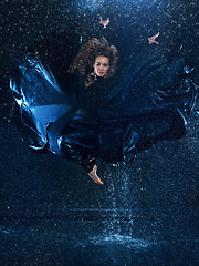 Image showing The young beautiful modern dancer dancing under water drops