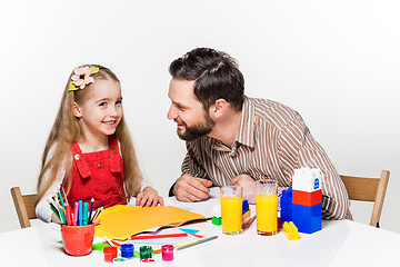 Image showing The daughter and father drawing together