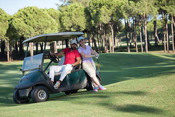 Image showing couple in buggy on golf course