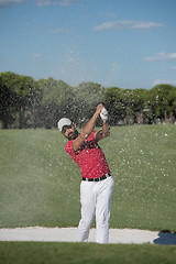 Image showing golfer hitting a sand bunker shot