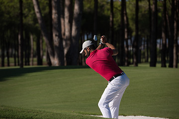 Image showing golfer hitting a sand bunker shot