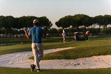 Image showing golfer from back at course looking to hole in distance