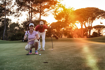 Image showing couple on golf course at sunset