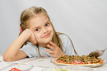 Image showing Little six year old girl sitting at the table waiting for about preparing pizza