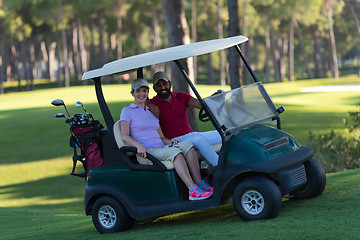 Image showing couple in buggy on golf course