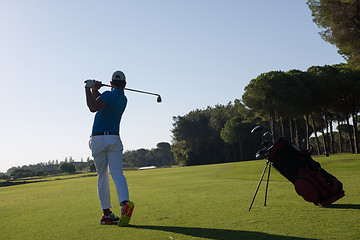 Image showing golf player hitting shot