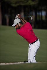 Image showing golfer hitting a sand bunker shot