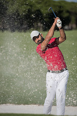 Image showing golfer hitting a sand bunker shot