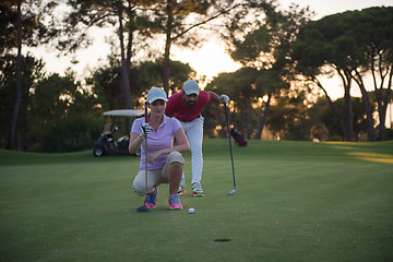 Image showing couple on golf course at sunset