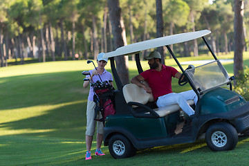 Image showing couple in buggy on golf course