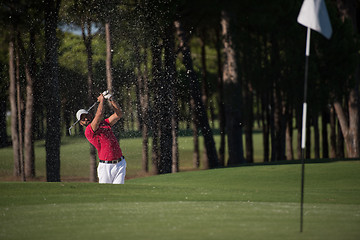 Image showing golfer hitting a sand bunker shot