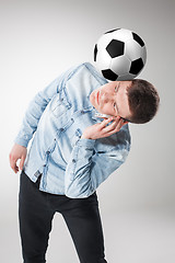 Image showing The portrait of fan with ball, holding phone on white background