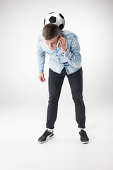 Image showing The portrait of fan with ball, holding phone on white background