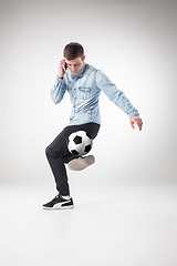 Image showing The portrait of fan with ball, holding phone on white background
