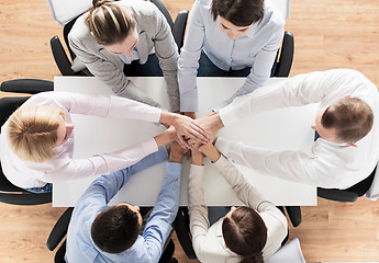 Image showing close up of business team with hands on top