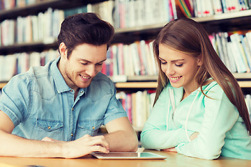 Image showing happy students with tablet pc in library