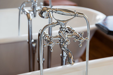 Image showing close up of bath tap and shower at bathroom