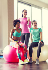 Image showing group of smiling women with exercise balls in gym