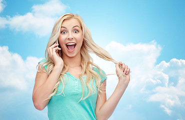 Image showing smiling young woman calling on smartphone