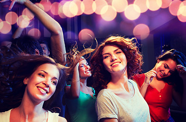 Image showing smiling friends dancing in club