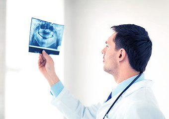 Image showing male doctor or dentist looking at x-ray