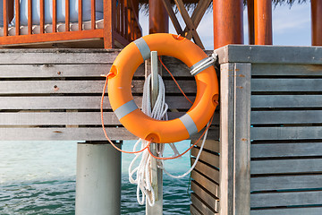 Image showing lifebuoy on beach patio or terrace in sea water