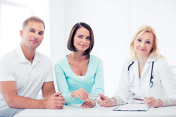 Image showing doctor giving pills to patients