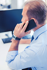 Image showing businessman with smartphone in office